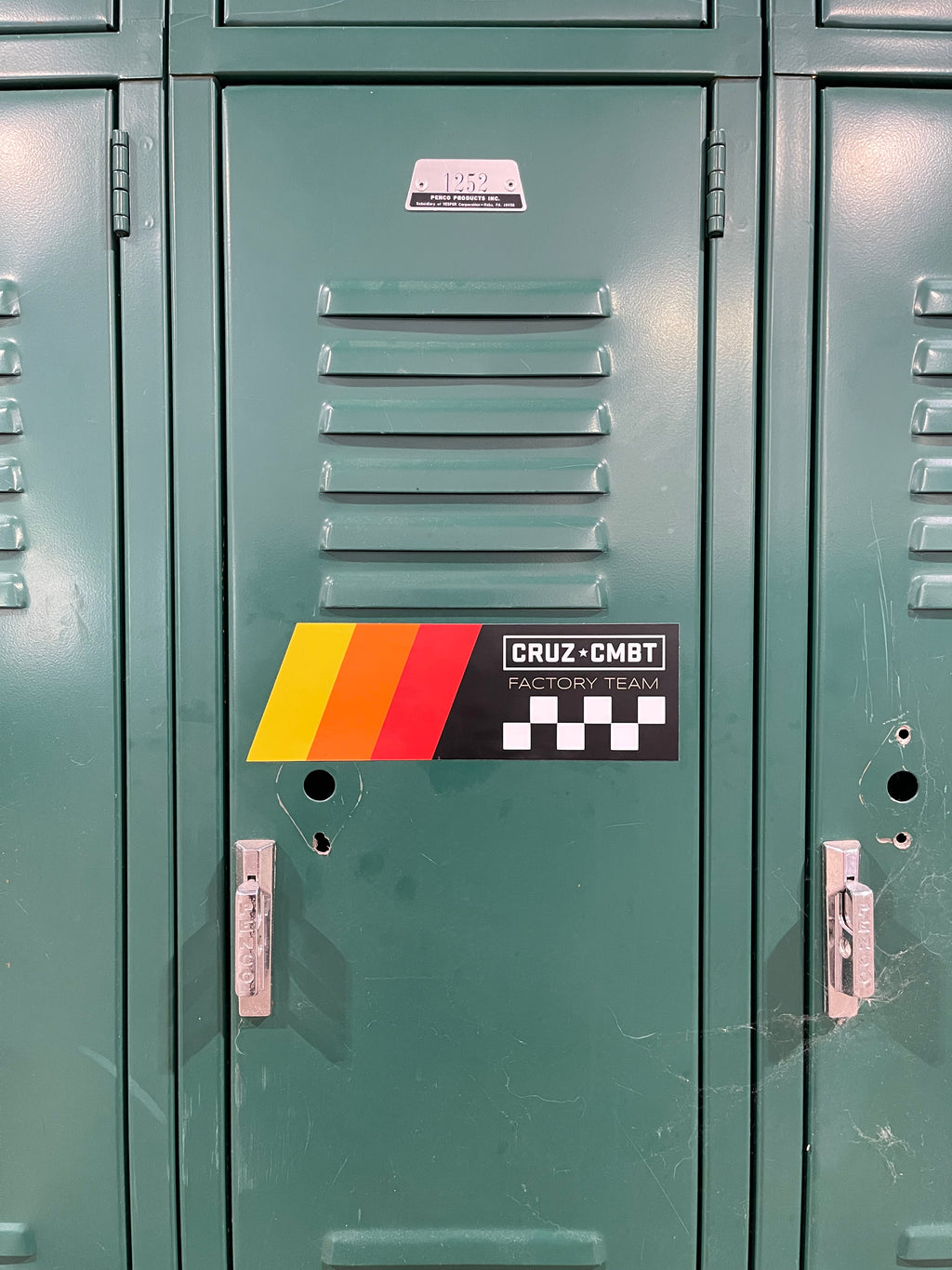 Factory Team sticker on a green metal locker